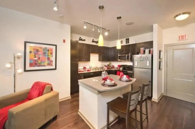 Living area and kitchen with island and seating. at Bears Tower- Newest Residential Units Next to MSU Campus in Springfield Student Accommodation