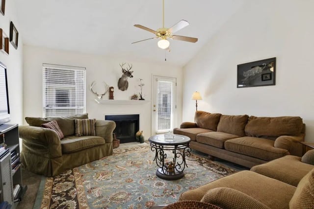 Two sofas fireplace rug living room at Beau Chene Condominiums, Inc in Baton Rouge Student Accommodation