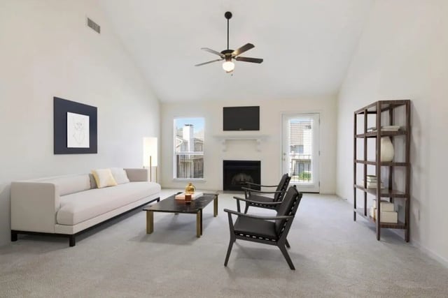 Sofa coffee table chairs fireplace shelving living room at Beau Chene Condominiums, Inc in Baton Rouge Student Accommodation