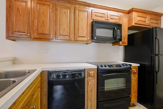 Sink dishwasher oven microwave refrigerator kitchen at Beau Chene Condominiums, Inc in Baton Rouge Student Accommodation