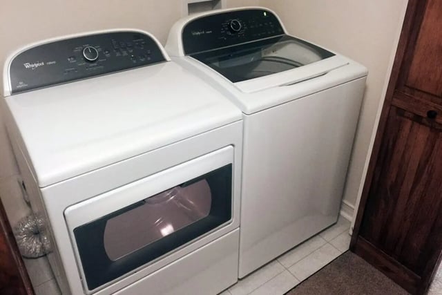 White washer and dryer appliances laundry area at Beau Chene Condominiums, Inc in Baton Rouge Student Accommodation
