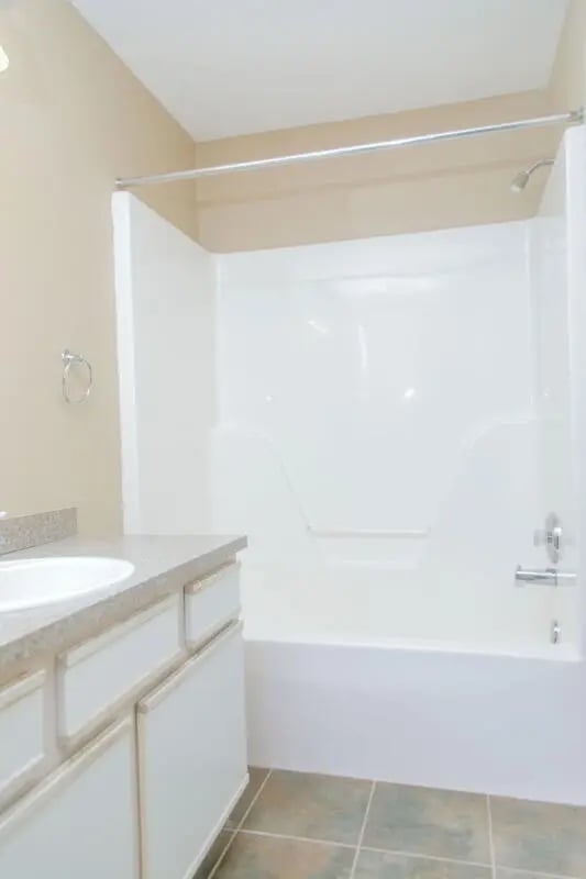 Sink cabinet shower tub tiled floor bathroom at Campus Crossing Apartments in Greensboro Student Accommodation
