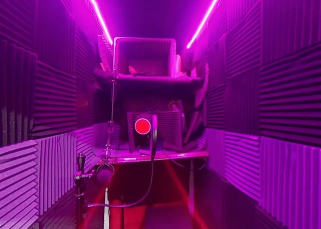 Sound booth with microphone and purple lighting study area at Artist Housing in Los Angeles Student Accommodation