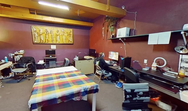 Bed with colorful blanket desk with computer study area at Artist Housing in Los Angeles Student Accommodation