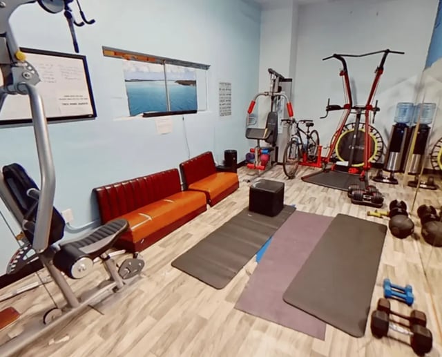Gym equipment with couches and yoga mats gym at Artist Housing in Los Angeles Student Accommodation