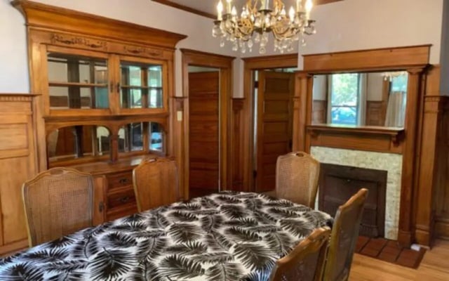 Dining table fireplace wood hutch chandelier living room at Copper Country Rentals in Houghton Student Accommodation