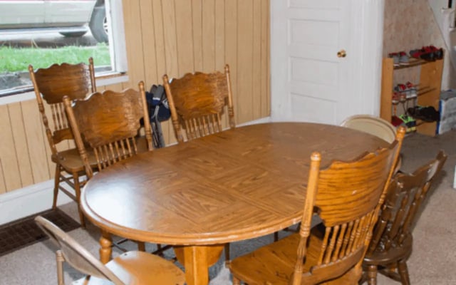 Wooden oval table with six chairs dining room at Copper Country Rentals in Houghton Student Accommodation