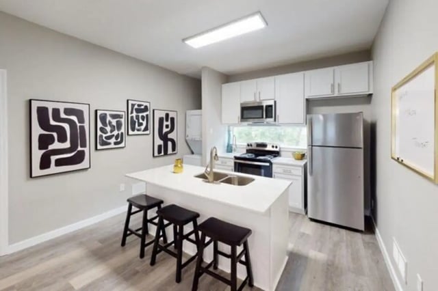 Kitchen island stools artwork and appliances kitchen at Altura Student Living in Tallahassee Student Accommodation