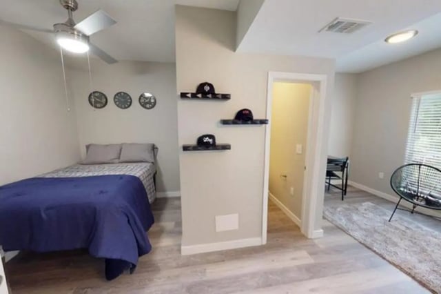 Bed ceiling fan clocks shelves and chair bedroom at Altura Student Living in Tallahassee Student Accommodation