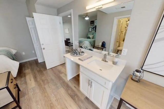 Vanity with sink mirror and bed bedroom interior at Altura Student Living in Tallahassee Student Accommodation