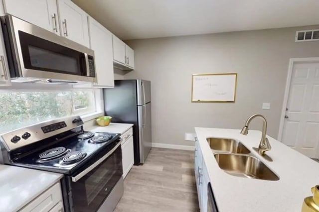 Stove refrigerator sink whiteboard kitchen at Altura Student Living in Tallahassee Student Accommodation