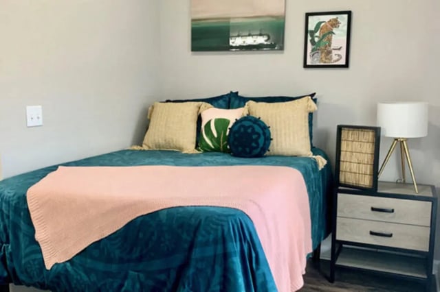 Bed with teal bedding and pink throw Bedroom at Altura Student Living in Tallahassee Student Accommodation