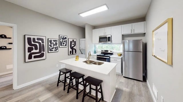 Kitchen island with stools and modern appliances kitchen at Altura Student Living in Tallahassee Student Accommodation