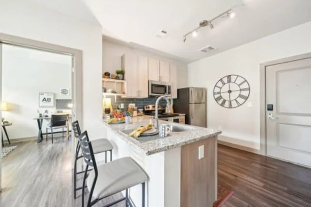 Island kitchen with counter stools and study area kitchen at Catalyst in Atlanta Student Accommodation