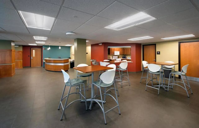 Dining tables with chairs and reception desk common area at Crosswalk Commons in West Lafayette Student Accommodation