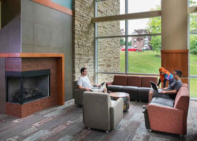 Sofa chairs fireplace lounge with students living room at Crosswalk Commons in West Lafayette Student Accommodation
