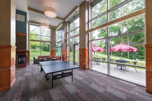 Ping pong table couches fireplace outdoor patio area living room at Crosswalk Commons in West Lafayette Student Accommodation