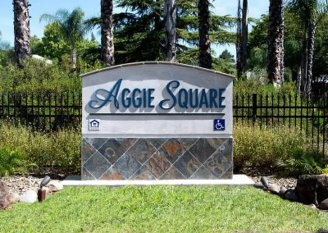 Aggie Square sign with house and handicap symbols exterior at Aggie Square Apartments in Davis Student Accommodation
