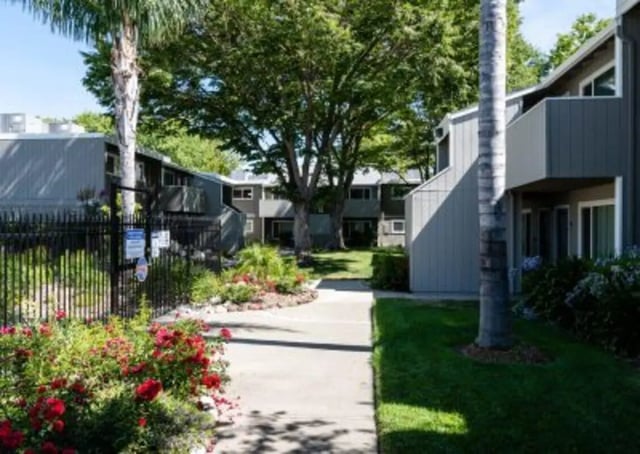 Apartment buildings with trees and flowers exterior at Aggie Square Apartments in Davis Student Accommodation