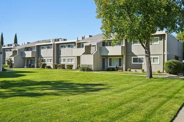 Apartment buildings with balconies and green lawns exterior at Aggie Square Apartments in Davis Student Accommodation