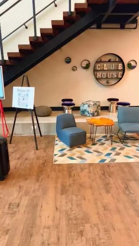 Clubhouse sign blue chairs orange table living room at Campus Heights in Athens Student Accommodation