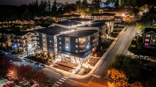 Modern apartment buildings with lit windows exterior at 500 Square Apartments in Bellingham Student Accommodation