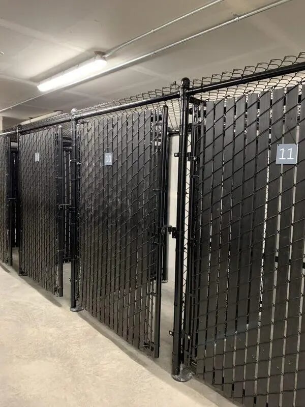 Black chain link storage units with numbers exterior at 500 Square Apartments in Bellingham Student Accommodation