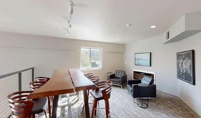Long table with chairs and seating area living room at 500 Square Apartments in Bellingham Student Accommodation