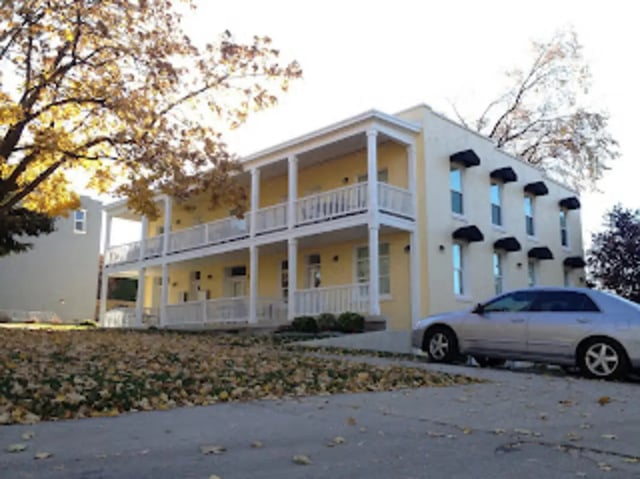 Yellow building with balconies and car exterior at City Creek Manor in Salt Lake City Student Accommodation