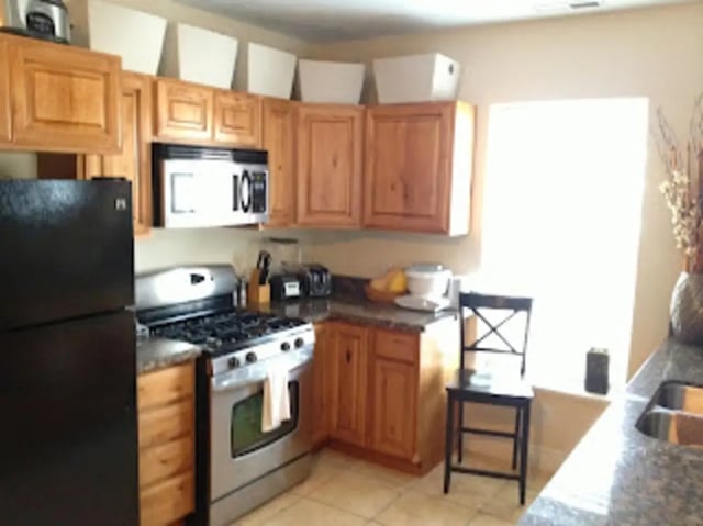 Refrigerator stove microwave cabinets chair kitchen at City Creek Manor in Salt Lake City Student Accommodation