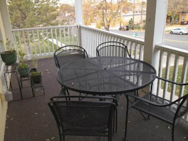 Patio table and chairs with plants balcony exterior at City Creek Manor in Salt Lake City Student Accommodation