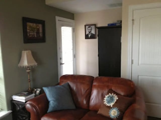 Brown leather couch with pillows and lamp living room at City Creek Manor in Salt Lake City Student Accommodation