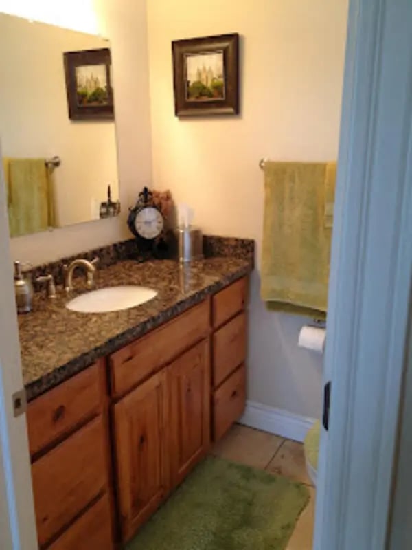 Vanity with sink towels and art Bathroom at City Creek Manor in Salt Lake City Student Accommodation