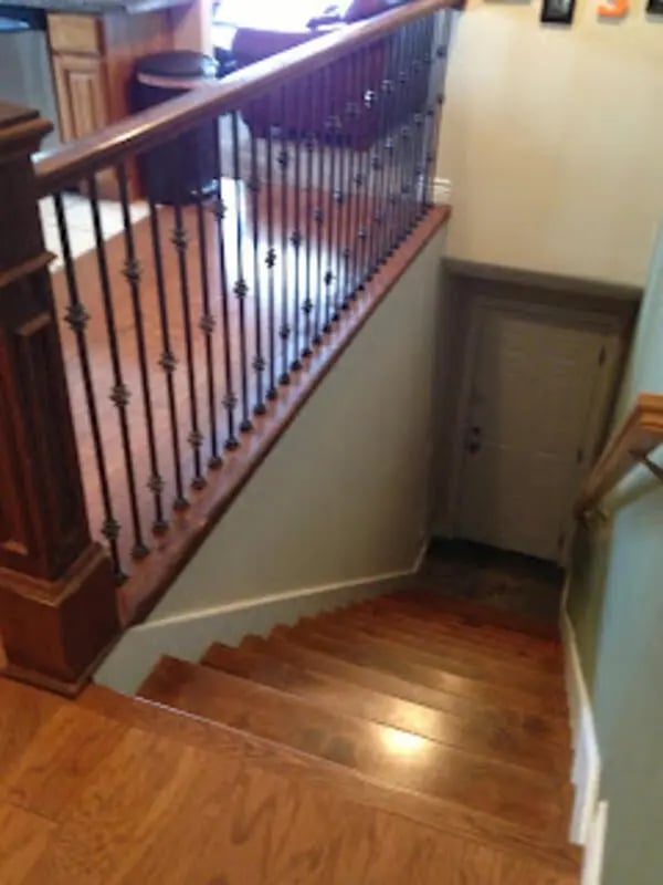 Wooden staircase with ornate railing interior hallway at City Creek Manor in Salt Lake City Student Accommodation