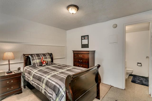 Bed dresser lamp pegboard and bathroom bedroom at Cobblestone Court Apartments in Tuscaloosa Student Accommodation