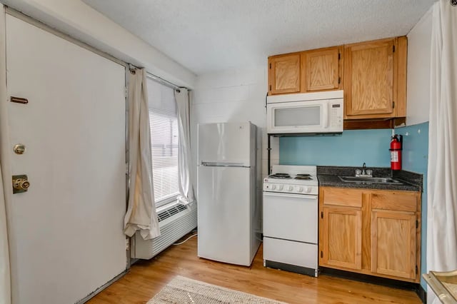 Refrigerator stove microwave cabinets kitchen at Cobblestone Court Apartments in Tuscaloosa Student Accommodation