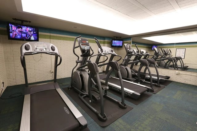 Treadmills elliptical machines and televisions gym. at Collegiate Communities in West Lafayette Student Accommodation