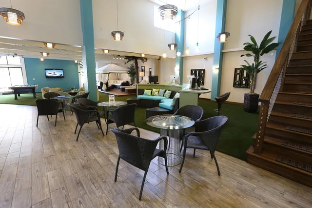 Chairs tables couches reception desk billiard table lounge area at Collegiate Communities in West Lafayette Student Accommodation
