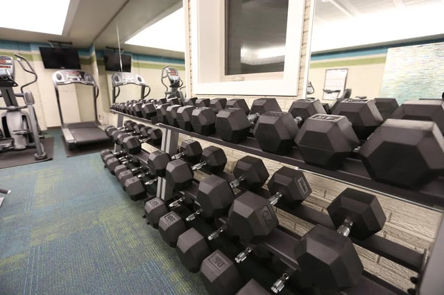 Dumbbell rack treadmills elliptical gym equipment gym at Collegiate Communities in West Lafayette Student Accommodation