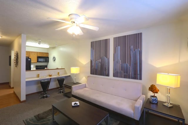 Sofa art kitchen bar stools dining area living room at Collegiate Communities in West Lafayette Student Accommodation