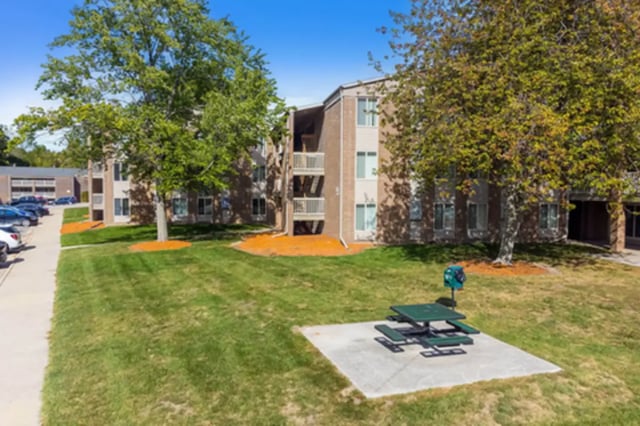 Apartment buildings trees picnic table exterior at Campus Hill Apartments in Ithaca Student Accommodation
