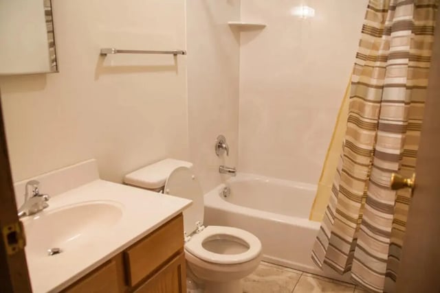 Sink toilet bathtub with striped shower curtain bathroom at Bridgerland Apartments in Logan Student Accommodation