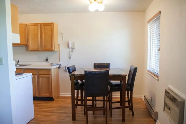 Kitchen dining table with four chairs and cabinets dining area at Bridgerland Apartments in Logan Student Accommodation