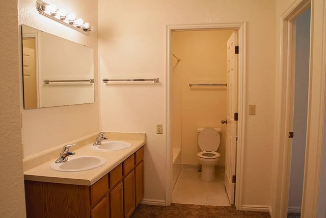 Double sinks and toilet visible bathroom at Bridgerland Apartments in Logan Student Accommodation
