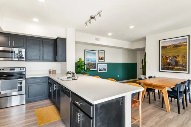 Kitchen island with dining table and chairs kitchen at Ascent at Campus of Life in San Diego Student Accommodation
