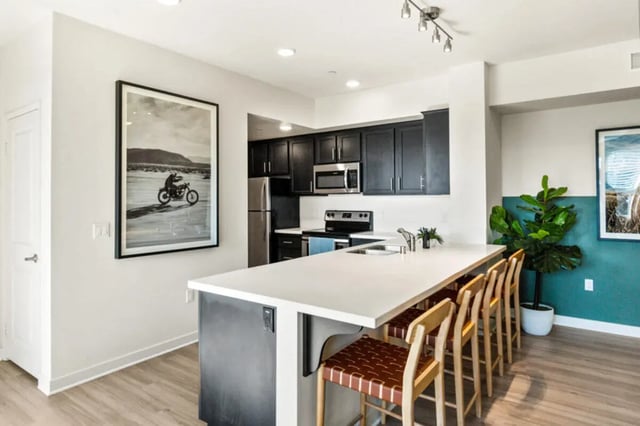 Modern kitchen island with stools and cabinets kitchen at Ascent at Campus of Life in San Diego Student Accommodation