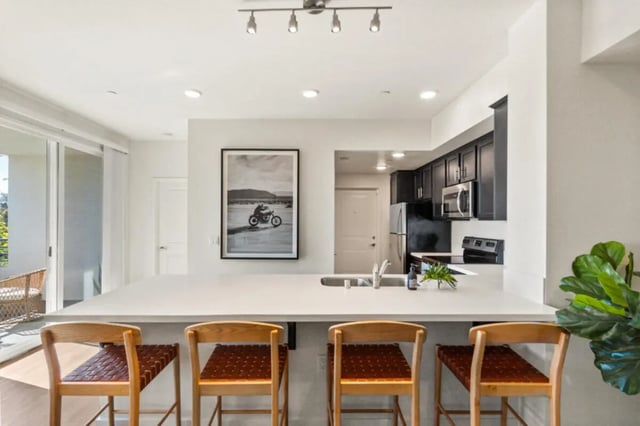 Four bar stools at a kitchen island kitchen at Ascent at Campus of Life in San Diego Student Accommodation