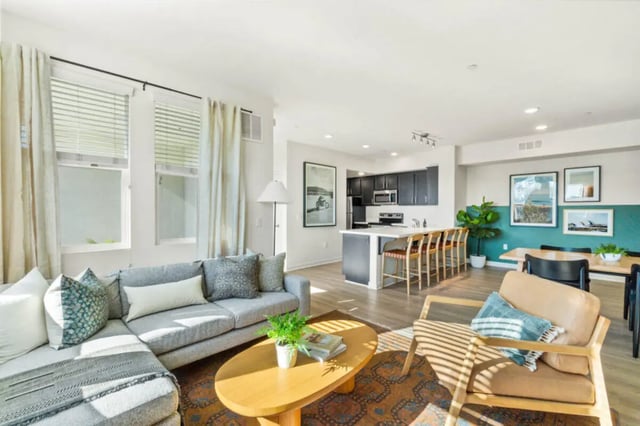 Sofa coffee table kitchen dining area living room at Ascent at Campus of Life in San Diego Student Accommodation