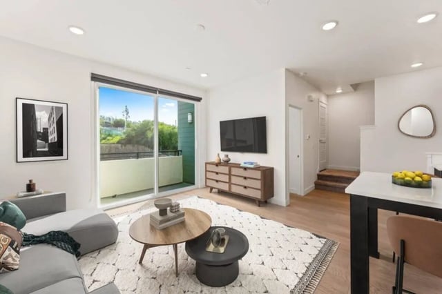 Modern living room with sectional sofa and television living room at Ascent at Campus of Life in San Diego Student Accommodation