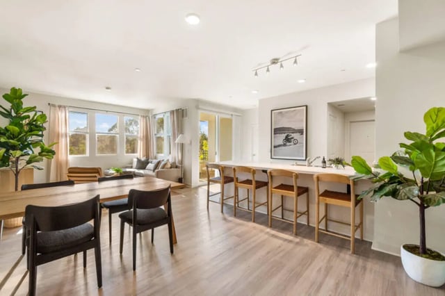 Dining table chairs counter with stools living room exterior at Ascent at Campus of Life in San Diego Student Accommodation